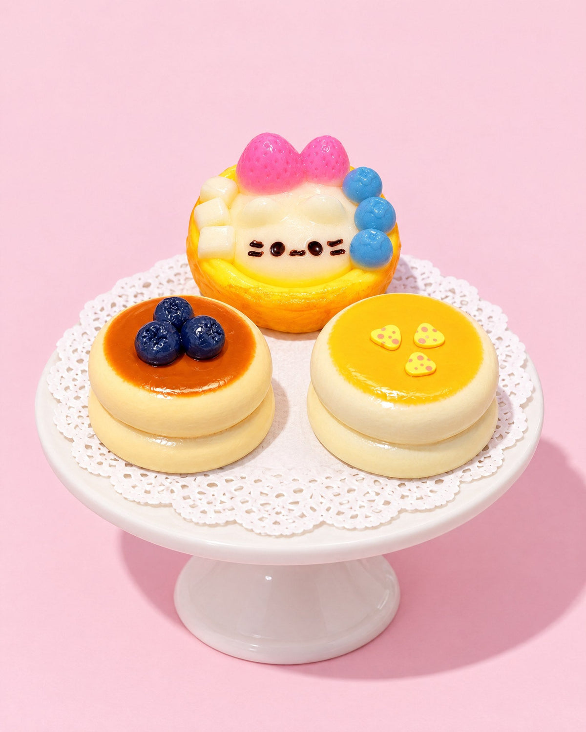 Kitten Patisserie squishies on a white cake stand