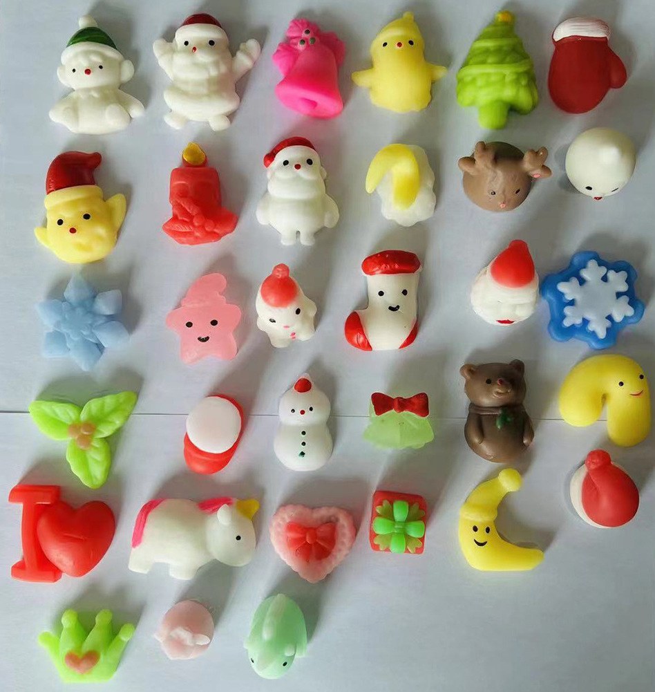 Supplier photo of the full Christmas mini squishy range laid out on white paper; you get designs at random