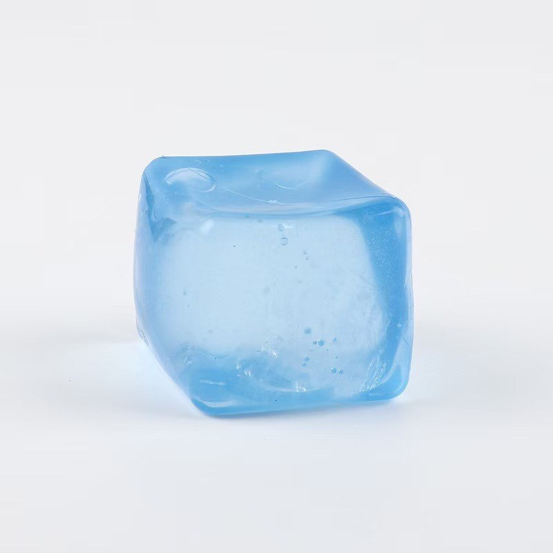 Real photo: solid blue Crystal Ice gel cube on a plain white background